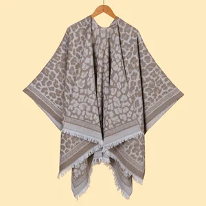 Detail of grey and beige leopard print knitted shawl with delicate fringe hem decoration