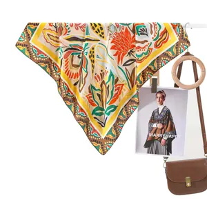 Elegant floral print silk scarf with bohemian patterns in warm yellow and red tones