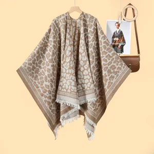 Detailed view of leopard print shawl featuring thick knit texture and white fringe tassels