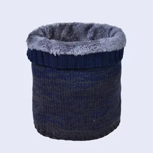 Close-up of thick grey plush lining and blue striped knit fabric of the winter neck warmer