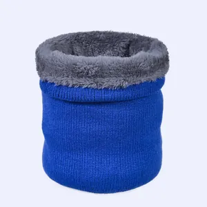 Detail of blue knitted neck warmer showing thick grey faux fur lining and soft texture