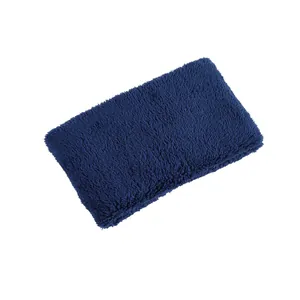 Macro detail of the thick, soft dark blue double-layer plush texture on the neck warmer