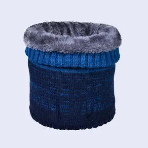 Detail of blue gradient knit scarf with thick grey faux fur lining for winter warmth