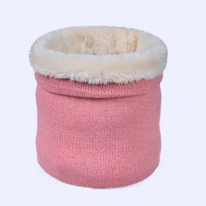 Detailed view of pink knitted neck warmer with thick white faux fur thermal lining