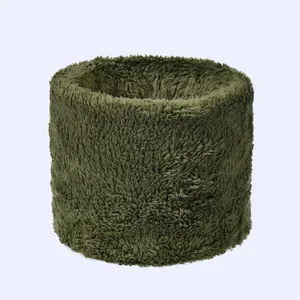Macro detail of the dark green plush fabric texture on a soft winter thermal neck warmer