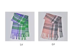Detail view of thickened plaid scarves in green-purple and pink-grey with fringe tassels