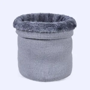 Detail of light grey knitted neck warmer showing soft thick faux fur lining texture