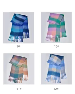 Detail of four colorful rainbow plaid scarves with thick yarn texture and long fringe