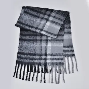 Thick checkered scarf in grey and black tones with long decorative tassel fringe edges