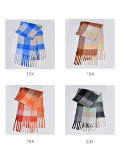 Detail of colorful plaid tassel scarves showing four thick knit patterns and long fringes