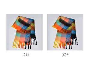Close-up of thick rainbow plaid scarf with long tassels and soft bouclé yarn texture