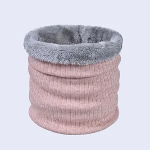 Close-up of pink ribbed knit fabric with soft gray fleece lining on a winter neck warmer