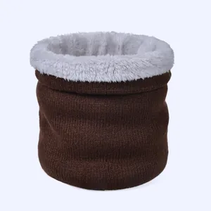 Close-up of winter knit neck warmer with dark brown texture and thick white fleece lining