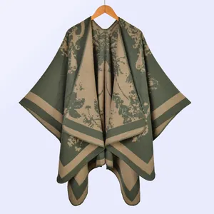 Detail of vintage knit shawl with green and khaki floral jacquard and thick texture