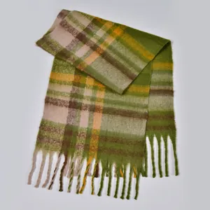 Detail of soft green plaid scarf with thick fringe and mohair-like fuzzy texture
