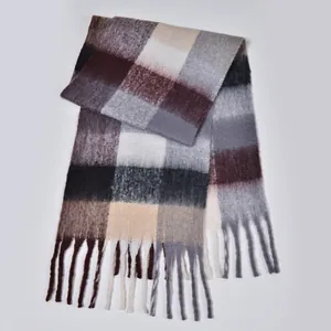 Close-up detail of the rainbow plaid scarf showing fluffy texture and soft fringe edges