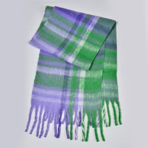 Detail of thick plaid scarf with purple and green patterns and soft tassel fringe