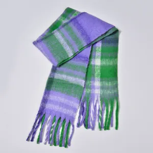 Detail of soft purple and green plaid bouclé scarf texture with elegant fringe tassels