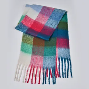 Close-up of thick rainbow plaid scarf featuring soft mohair texture and chunky tassel details