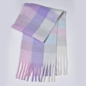 Detailed view of soft rainbow plaid scarf with long tassels and pastel fiber texture