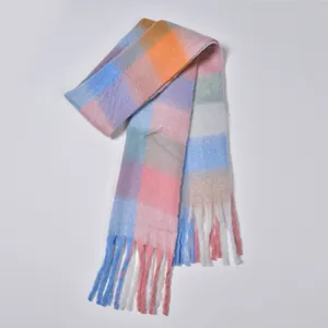 Close-up of thick rainbow plaid scarf featuring soft fleece texture and long fringe tassels