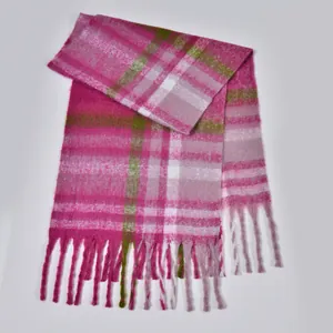 Close-up of thick plaid scarf with pink texture and long decorative fringes
