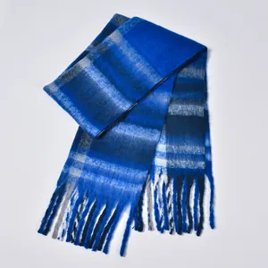 Close-up of thick plaid boucle scarf in royal blue with decorative long tassels