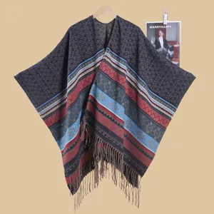 Close-up of geometric diamond pattern and fringe detail on the ethnic knit hooded poncho