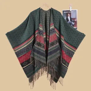 Detailed knit texture of ethnic shawl with geometric diamond patterns and long fringe