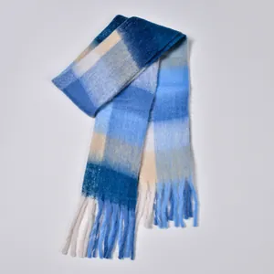 Close-up of rainbow plaid scarf with soft blue and beige tassels and thick knit texture