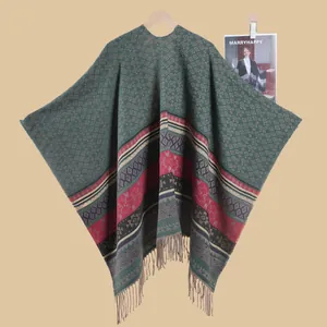 Detail of vintage knit poncho featuring ethnic diamond patterns and colorful tassel edges