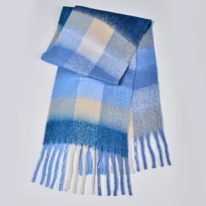 Detail of soft rainbow plaid scarf featuring long tassels and thick fuzzy knit texture
