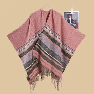Close-up of geometric knit shawl showing soft texture and fringe hem detail