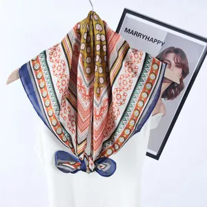 Bohemian geometric print silk scarf tied in a bow on a white sleeveless top