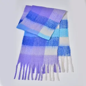 Detail of soft purple and blue rainbow plaid scarf with thick knit texture and long tassels