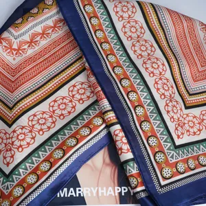 Women's silk scarf with orange floral prints and geometric borders for spring fashion