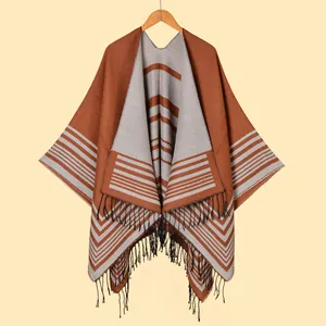 Caramel and grey knitted poncho cape with geometric stripes and fringe tassel hem