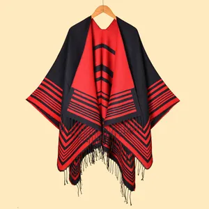 Women's knit poncho with classic red and black stripes and elegant tassel fringe trim