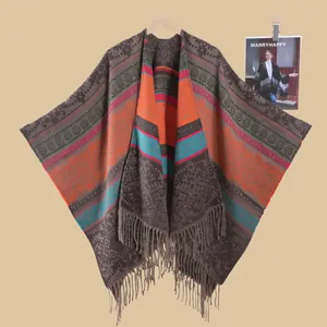 Bohemian knit poncho with vibrant floral jacquard patterns and tassel hem for travel