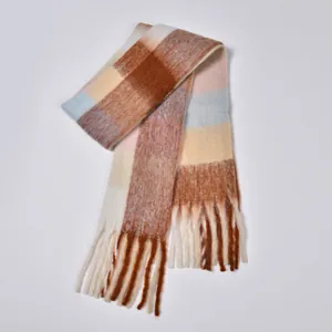 Close-up of thick rainbow plaid scarf texture with soft pastel tassels and woolly yarn