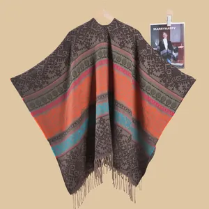Detailed view of bohemian floral jacquard poncho with soft tassel fringe and paisley patterns