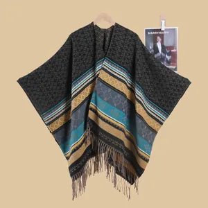 Detail of bohemian knit shawl featuring geometric diamond patterns and fringe tassels