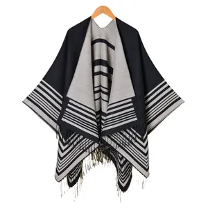 Women's minimalist black and white striped knit shawl poncho with fringe trim