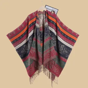 Ethnic style knitted poncho with colorful geometric patterns and decorative tassels