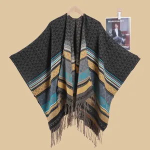 Detail of ethnic geometric diamond knit poncho shawl featuring decorative fringe edges