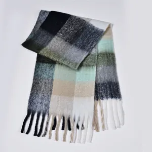 Close-up of rainbow plaid scarf showing fluffy boucle yarn texture and long fringe details