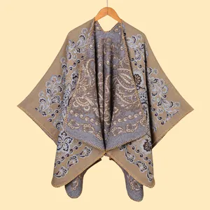 Close-up of bohemian paisley jacquard pattern and blanket-stitched edge on thick shawl