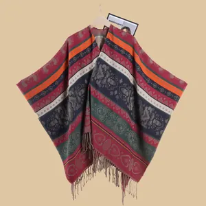 Detail of bohemian style poncho with colorful geometric patterns and long tassels