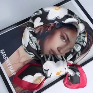 Floral watercolor print silk scarf with red border in a stylish looped arrangement