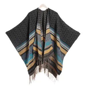 Ethnic bohemian poncho shawl for women featuring geometric diamond patterns and tassel trim